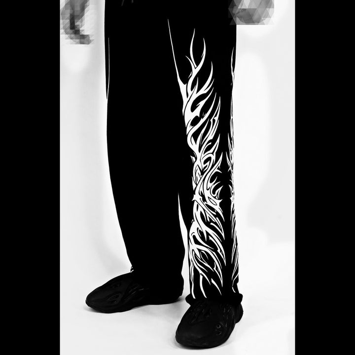 Black pants with white tribal design on a white background